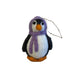 Felted penguin ornament on a textured surface
